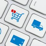 Online shopping / ecommerce and retail sale concept : Shopping cart, delivery van, credit card, world globe logo on a laptop keyboard, depicts customers order things from retailer sites using internet