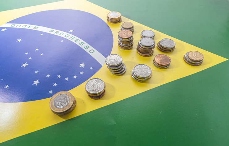 Translation order progressBrazilian flag with Brazilian real coins,concept of decay of Brazilian money.