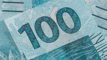 Brazil money, a bundle of 100 reais banknotes, financial concept, close up
