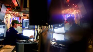 A trader works on the floor of the New York Stock Exchange (NYSE) in New York. Photographer: Michael Nagle/Bloomberg