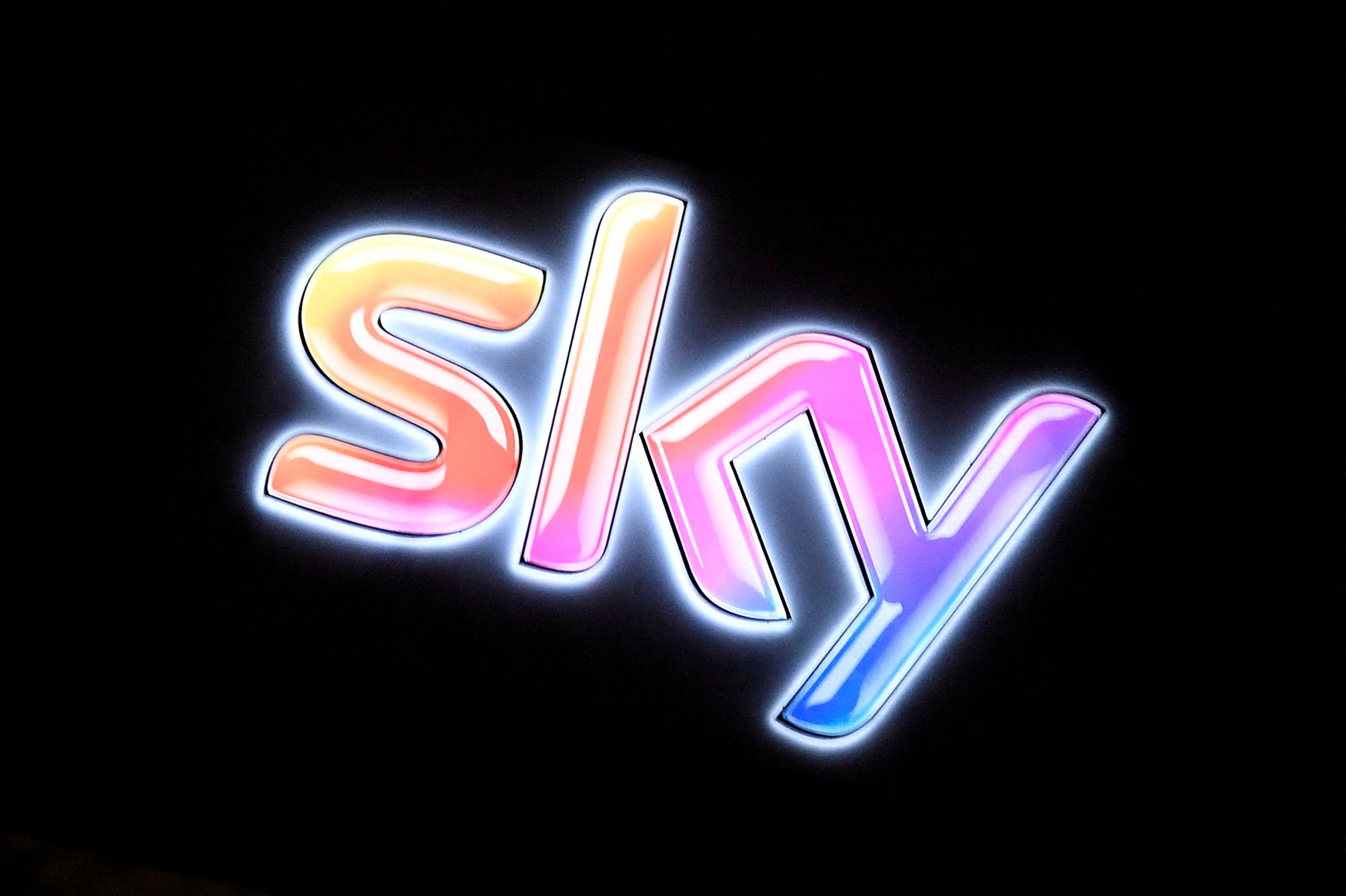 FILE PHOTO: FILE PHOTO: The Sky logo is seen illuminated on the outside of a building at the company's headquarters in West London, Britain, January 25, 2017. REUTERS/Toby Melville/File Photo