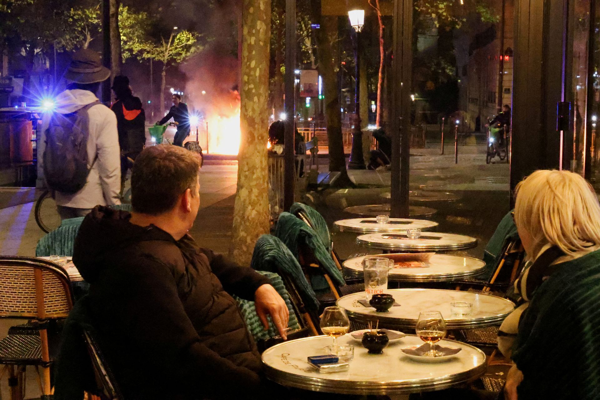 Cafés abertos e ruas em chamas: os dois mundos na noite “surrealista” de Paris